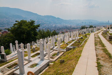 Fototapeta na wymiar Martyrs’ Cemetery Kovaci: White graves of the muslim graveyard on the hill above the city. Total number of deaths during the Bosnian War (1992-1995) was 110,000 people 