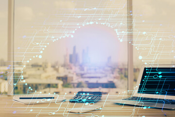 Double exposure of desktop computer and technology theme hologram. Concept of software development.