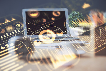 Computer on desktop in office with technology theme hologram. Multi exposure. Tech concept.