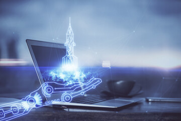 Desktop computer background in office and start up theme hologram drawing. Double exposure. Startup concept.