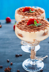 luxury tiramisu dessert in a cocktail glass decorated with cocoa