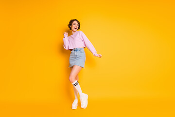 Fototapeta na wymiar Full length body size view of her she nice attractive lovely pretty charming slender skinny cheerful cheery girl having fun isolated on bright vivid shine vibrant yellow color background
