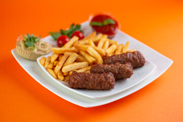 Traditional Romanian Dinner With Meatballs Or Mici And French Fries