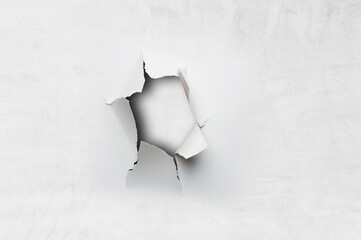 Hole in paper on white background