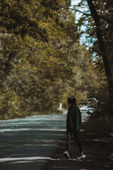 Obraz premium The girl walks alone near a forest 
