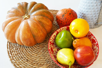 Autumn Halloween or thanksgiving day table setting. pumpkin, plate with vegetables on wooden table. Thanksgiving background . Top view