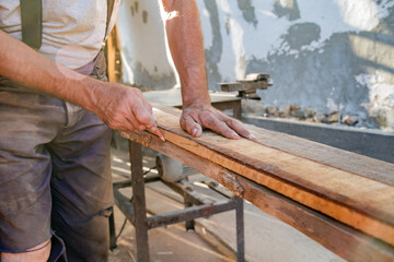 Carpenter using vintage electric circular saw.