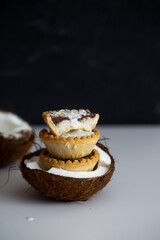 Vegan coconut tartlets on white background with copy space