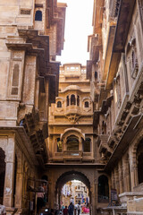 Fototapeta na wymiar The lane in front of bagore ke haveli in rajasthan. Streets of Jaisalmer city also known as golden city due to yellow sandstone buildings.