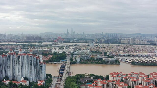 Open view of Guangzhou metropolis city with living blocks, river and Downtown buildings in far distance, on a cloudy overcast day .Guangdong, China.