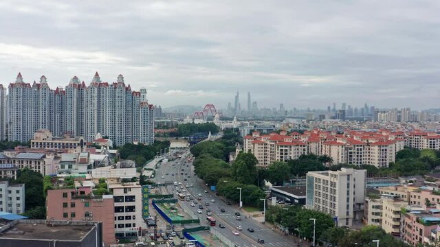 Open view of Guangzhou metropolis city with living blocks, river and Downtown buildings in far distance, on a cloudy overcast day .Guangdong, China.