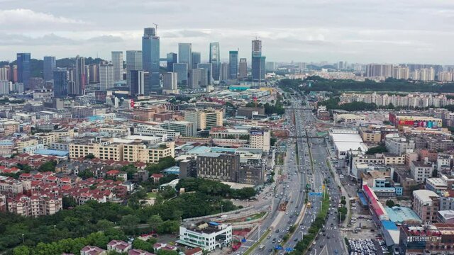 New development area with office buildings with a busy highway  in Guangzhou on a cloudy overcast day, Guangdong, China