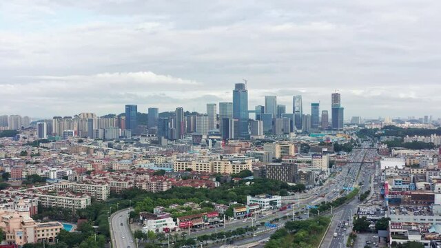 Rise up shot over new development area with office buildings  in Guangzhou on a cloudy overcast day, Guangdong, China