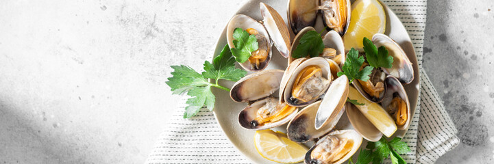 Cooked clams in a ceramic plate on a light gray table. Seafood dish. Banner	 - obrazy, fototapety, plakaty