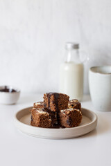 Homemade chocolate vegan brownies with coconut milk on white table