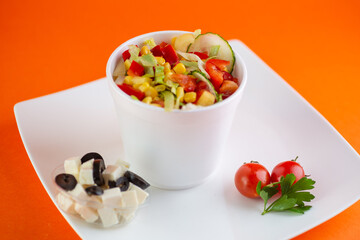 A close-up of a rustic Greek salad with feta cheese