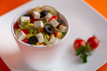 A close-up of a rustic Greek salad with feta cheese
