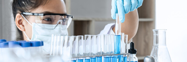 Biochemistry laboratory research, Chemist is analyzing sample in laboratory with equipment and...