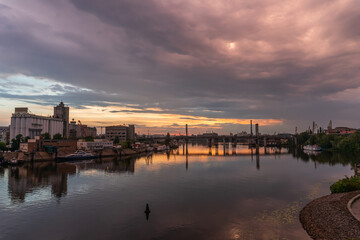 Fototapeta premium Kiev (Kyiv), Ukraine - June 15, 2020: Dnipro river and industrial area during the sunset