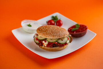 Falafel vegetarian burger with vegetables isolated on white plate