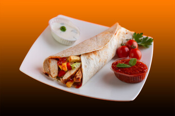 Grilled chicken in sandwich from fresh pita bread with onion and greens on  white plate