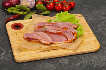 Sliced smoked duck breast served salad