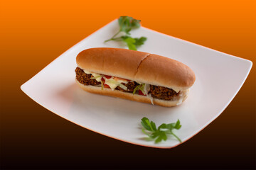 Turkish hot dog with falafel patties,thick layer of hummus, salad leaves,cucumbers,tomatoes and onions