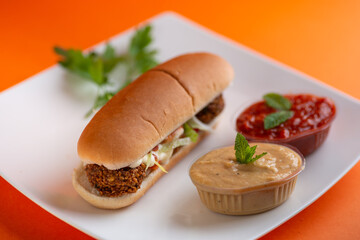 Falafel vegetarian burger with vegetables isolated on white plate