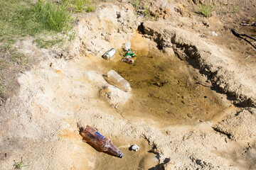 sand by the lake debris and dirt left behind by vacationers