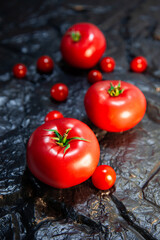 red tomatoes on a black coal table