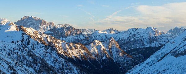 Winter panoramic view of mountains at sunset in the Dolomites range in Italy.