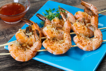 Grilled prawn skewer with sauce