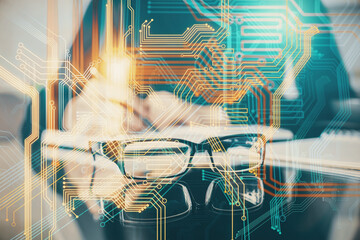 Double exposure of hands making notes with world map hologram and data theme icons. Concept of global computer data.