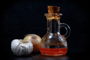 smal carafe with a mix of olive oil, garlic, onion and red pepper