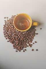 The coffee cups and roasted coffee beans were placed on a white table by the window in the dining room, as the coffee beans were prepared for filming a drink menu. Top View and Copy Space