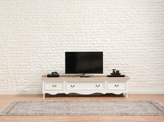 Decorative white classic television unit and brick wall background.