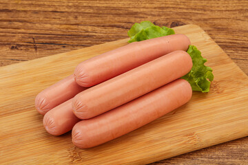 Tasty meat sausages over board