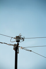 Obraz premium Electric wires against the blue sky