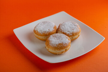 Yummy yellow dougnuts with granulated sugar.