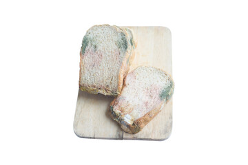 Moldy Whole wheat bread loaf on cutting board over white background.