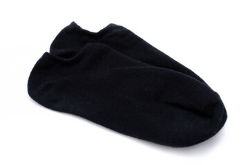 A pair of black unisex short socks on a white background. Black sports short socks in macro. Sweet socks