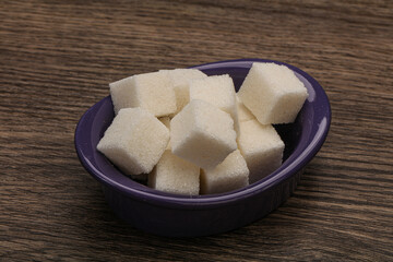 Refined white sugar cubs in the bowl