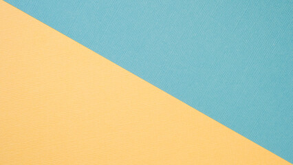 Textural background in trendy pastels: grey and rich yellow in a minimalistic concept. Flat lay, top view