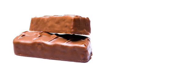 Two small snickers bars weighing 50 grams without packaging in macro are lying next to each other. Snickers two sticks, chocolates