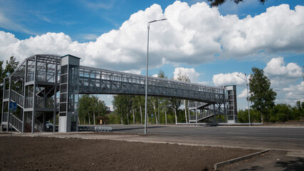 Pedestrian crossing over road. Empty road. Cityscape.
