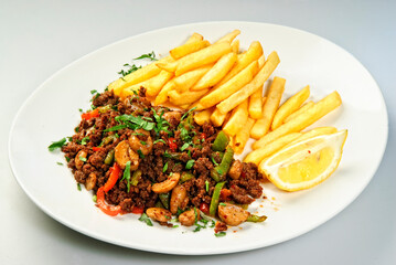 French fries served with baked meat.