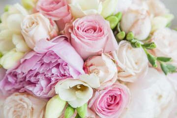Closeup of a bouquet of flowers consisting of geraniums, carnations, roses in bright wedding colors