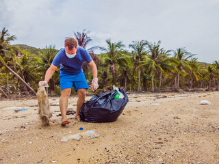 Man in gloves pick up plastic bags that pollute sea. Problem of spilled rubbish trash garbage on...