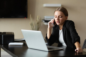 beautiful caucasian woman talking on the phone and thought. Does his work from home.