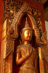 Fototapeta premium Gold Colored Wooden Sculpture in the Ancient Temple, Ayutthaya Historical Park, Thailand